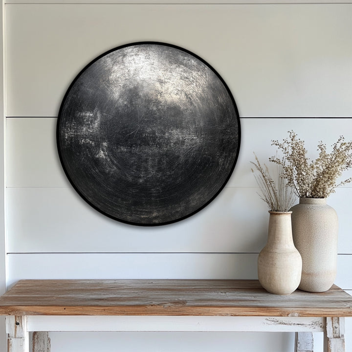 Depth and layers are highlighted in this industrial black textured abstract circle canvas painting, creating modern, minimal wall art with intriguing dimension.