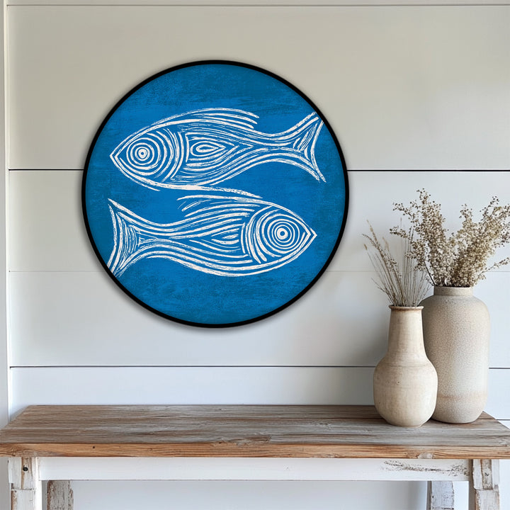 Swirling lines bring a vibrant sense of motion to this minimalist blue fish sketch round framed canvas print, capturing the energy of coastal wall art.