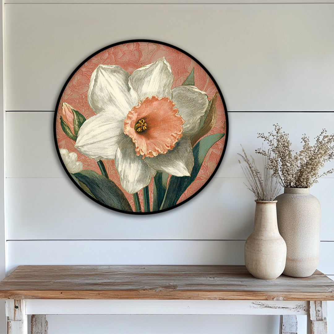Featuring a striking color contrast, the vintage daffodil bloom round premium canvas decor art showcases a light floral against a coral botanical backdrop.