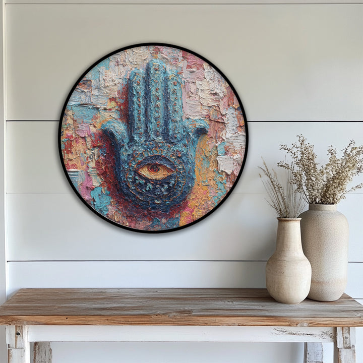 Impasto brushstrokes create a vibrant visual rhythm in this round canvas painting featuring a mystic hand with a spiritual eye, a colorful hamsa wall art design.