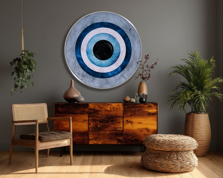 Stillness encompasses the blue evil eye symbol on a round framed canvas, a minimal protection wall art piece exuding tranquility in the room.