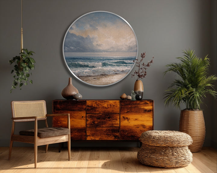 Rough canvas artwork texture is visible in this round print of coastal waves meeting the sandy shore, a classic seascape surface.