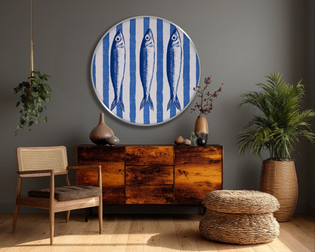 Featuring the smooth finish, the round blue coastal fish illustration canvas painting offers nautical striped wall art with a clean, frameless look.