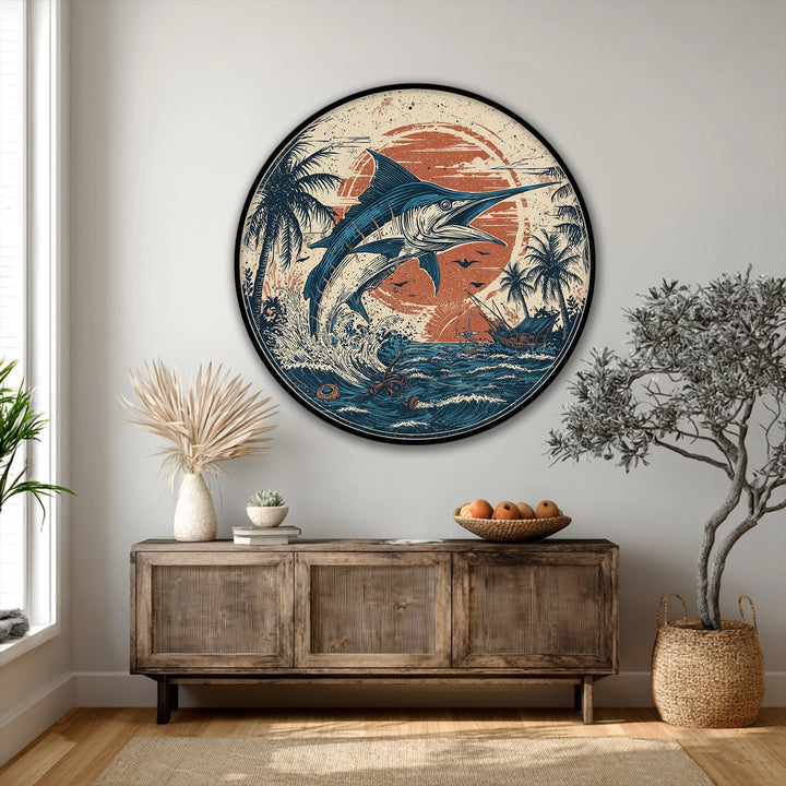 Featuring high quality canvas prints, the round wall art showcases a marlin, ocean waves, sun, and palm trees, set within a perfect circle, softened by organic shapes.