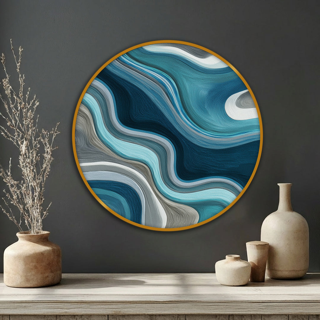 Showcasing the organic forms of this fluid teal waves round canvas pictures art, the abstract design features undulating curves in shades of blue and gray.