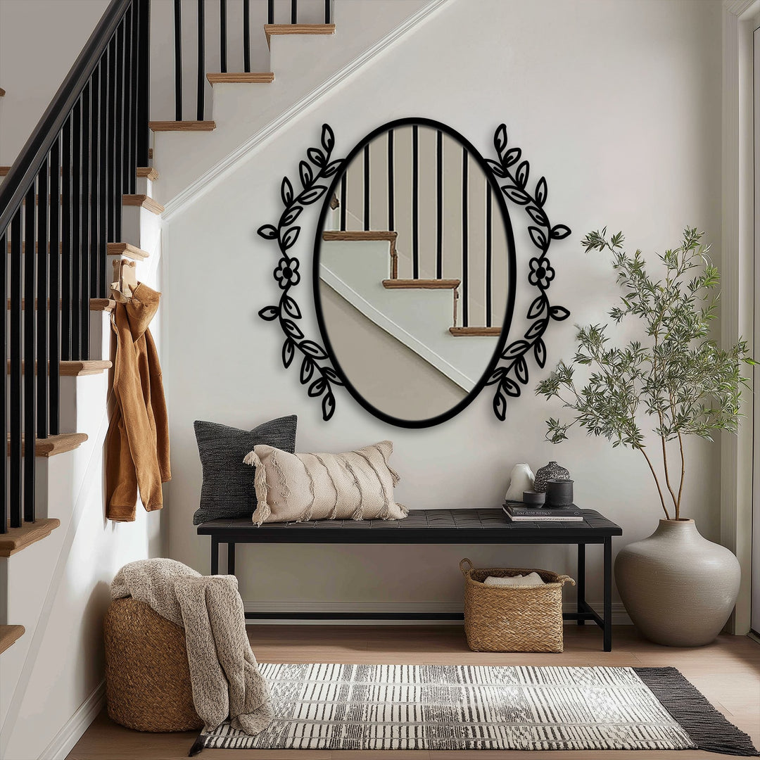 Botanical elegance oval floor mirror, a focal point with floral vine frame, adds unique home decor to an entryway alongside a wooden bench and woven rug.