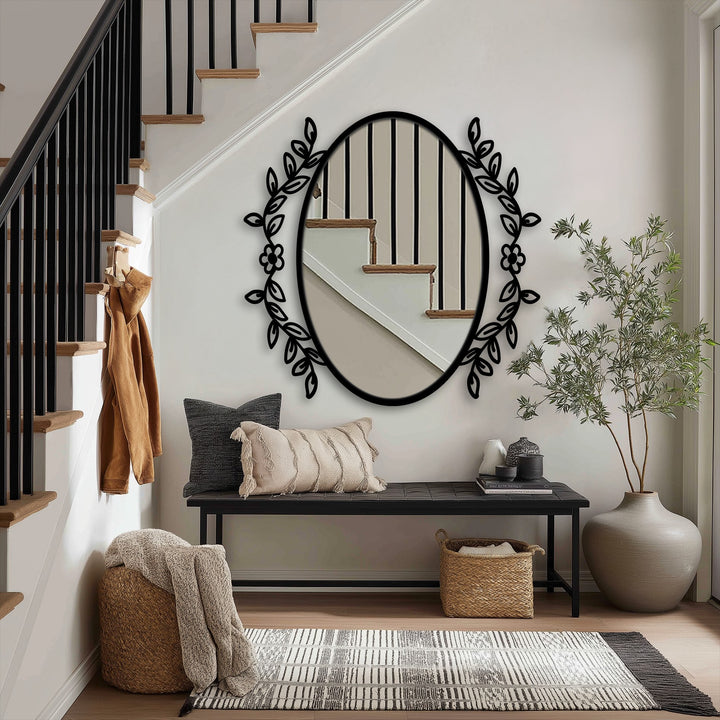 Botanical elegance oval floor mirror, a focal point with floral vine frame, adds unique home decor to an entryway alongside a wooden bench and woven rug.