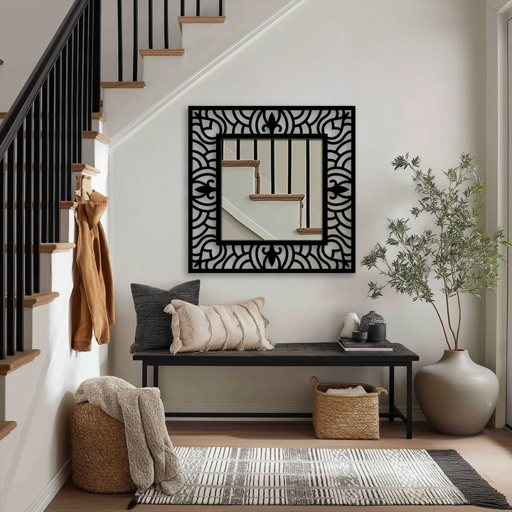 Visual rhythm is created by the ornate, repetitive wave pattern in the frame of this square floor mirror, an example of unique metal wall decor.