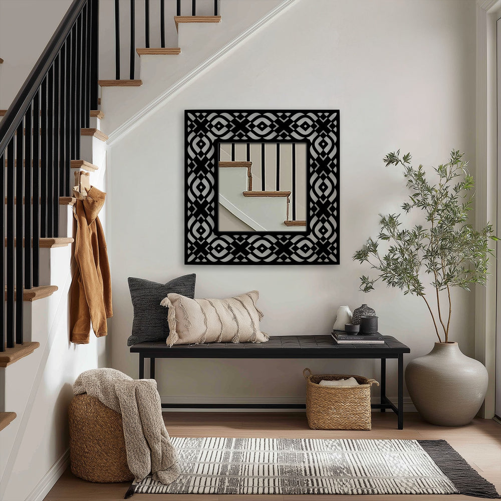 Foreground shows a woven basket near a tribal pattern floor mirror, exemplifying decorative metal art in a stylish, modern entryway.