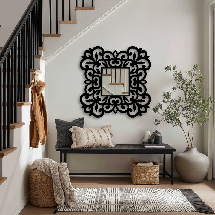 Ornate metal floral scroll frame surrounds the square floor decorative mirror, making it the loudest element in this curated entryway metal art for wall design.
