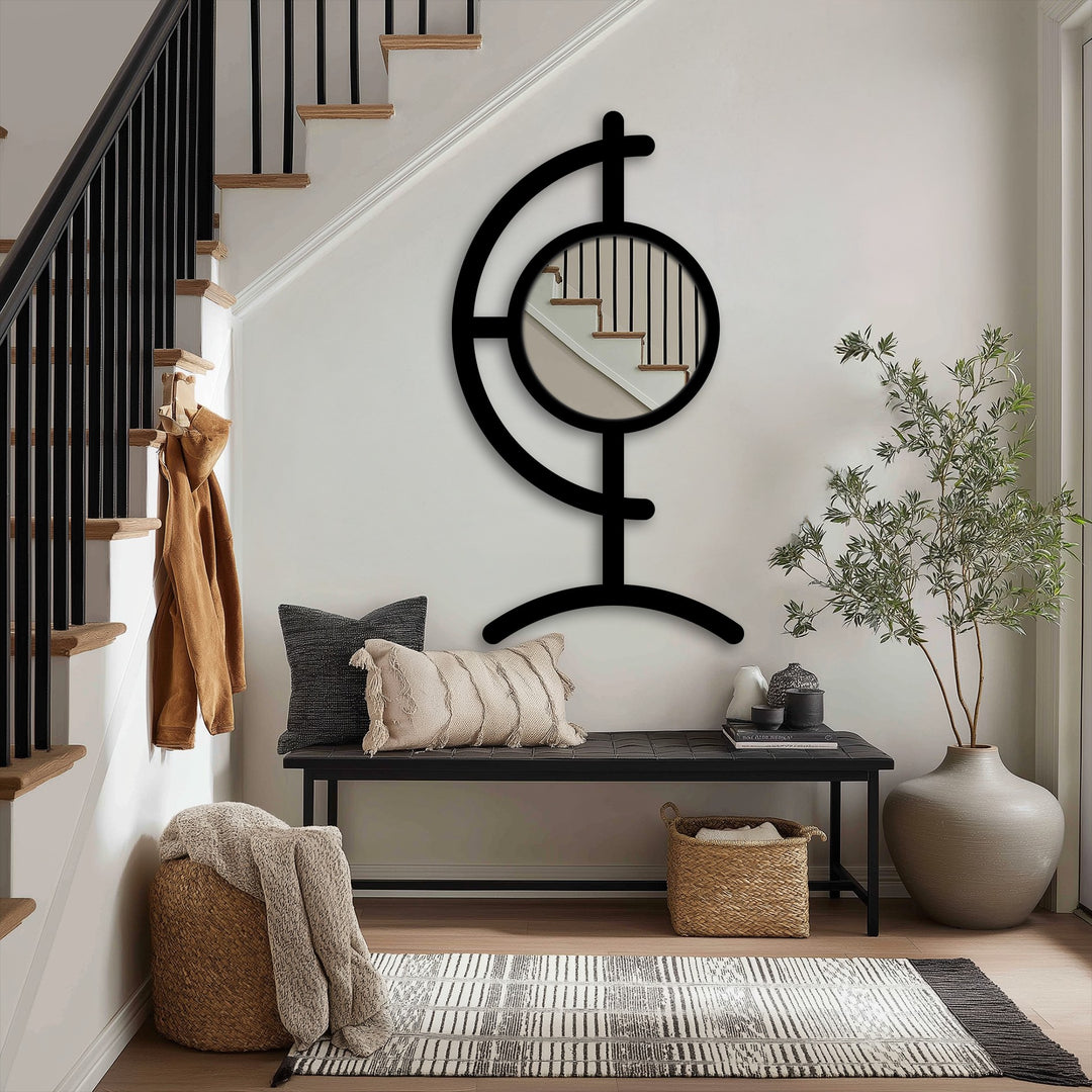 Sculptural black metal floor mirror showcases a modern design with its round center reflecting the staircase, making it a unique metal wall art focal point.