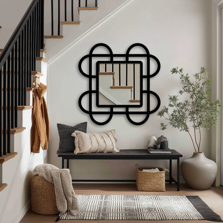 Moderately saturated, the looped squares modern mirror reflects a section of the stairway, creating a focal point in the entryway's design.