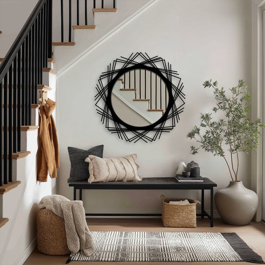 Highlighting the loudest element, a round decorative wall mirror with a crossed line halo frame exemplifies modern mirror design in an entryway home decor setting.