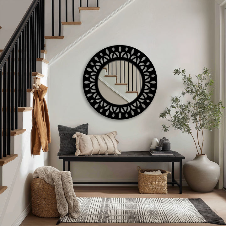 Stillness pervades the entry as a black metal leaf motif round floor mirror reflects the staircase, embodying the essence of decoration wall art.