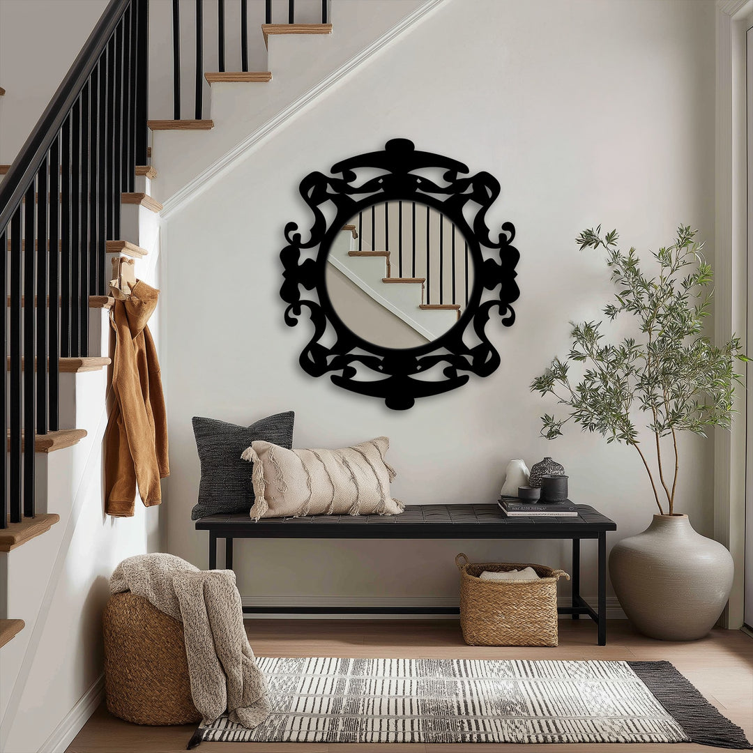 Light and shadow play across the ornate black metal frame of the modern mirror, reflecting the stairway and nearby decor with subtle gradations.