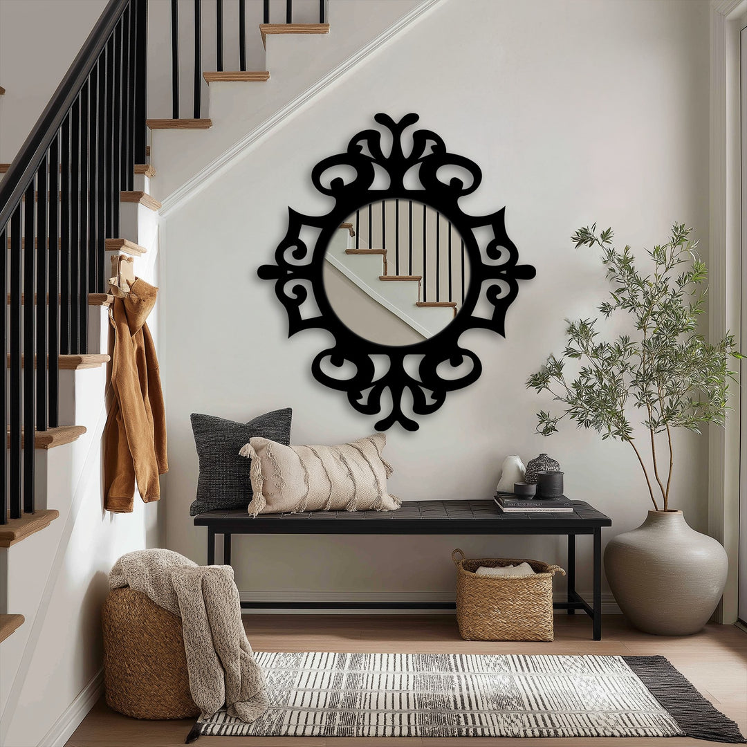 Black ornate frames define the darkest area around a decorative round stained glass wall mirror reflecting stairs in an elegant entryway.