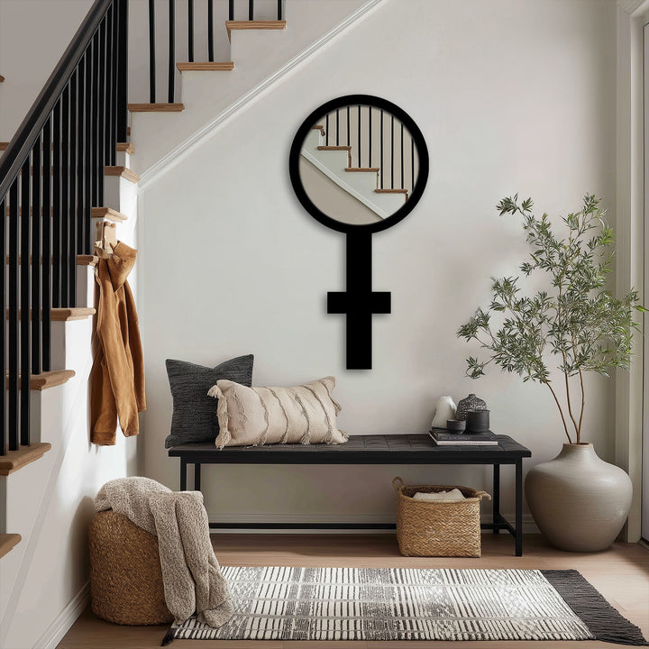 Foreground shows a decorative arrangement with modern wall mirrors, a cushioned bench, woven basket, and textured rug creating an inviting entryway.