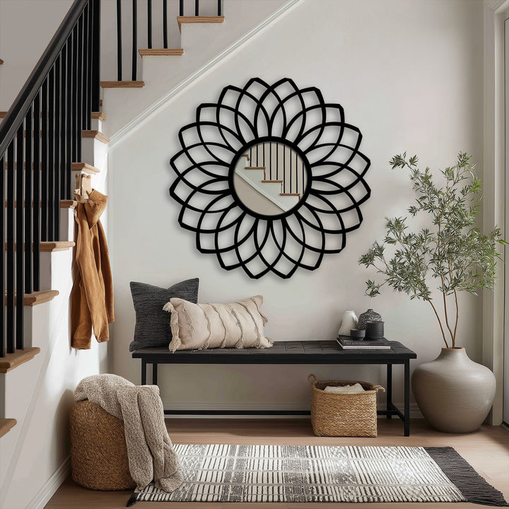 Soft pillow resting near a decorative layered petal floor mirror brings a touch of cozy elegance to this modern mirror reflecting the staircase.