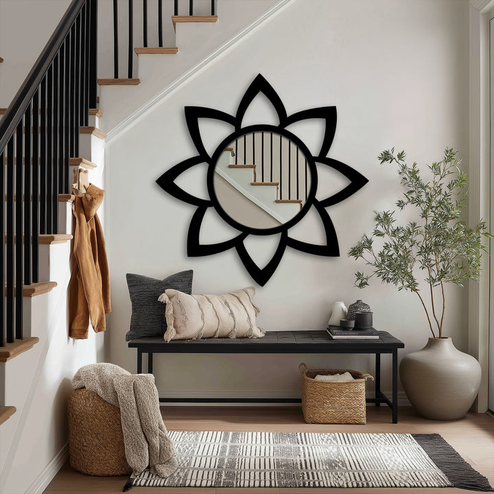 Shadows dance across the wall around the petal-shaped stained glass wall mirror, highlighting the light reflected within its minimalist design.