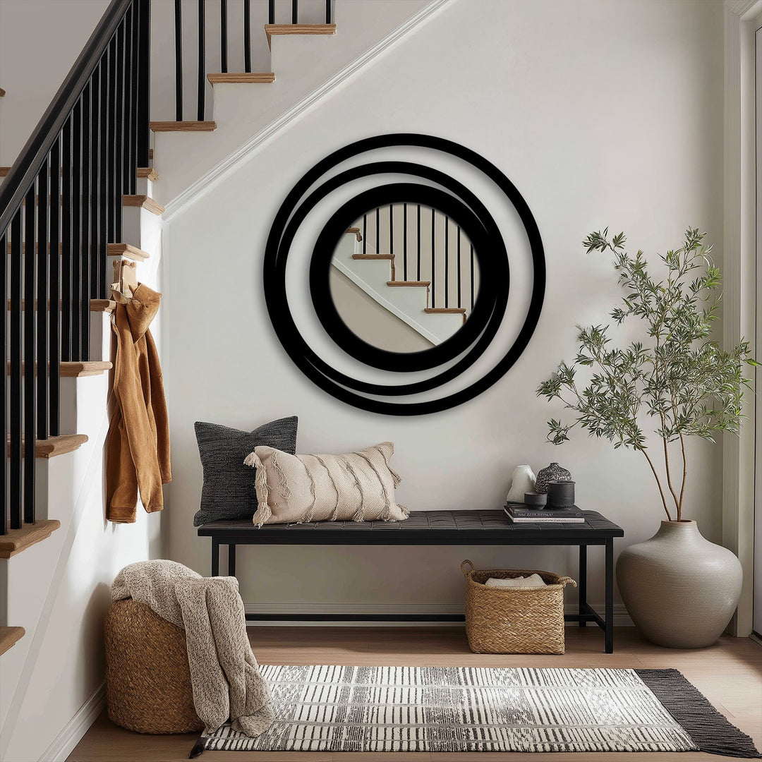 Highlighting the abstract quality, this modern mirror presents concentric circles in a ring design, offering a layered and visually captivating metal artwork that complements the minimalist style.