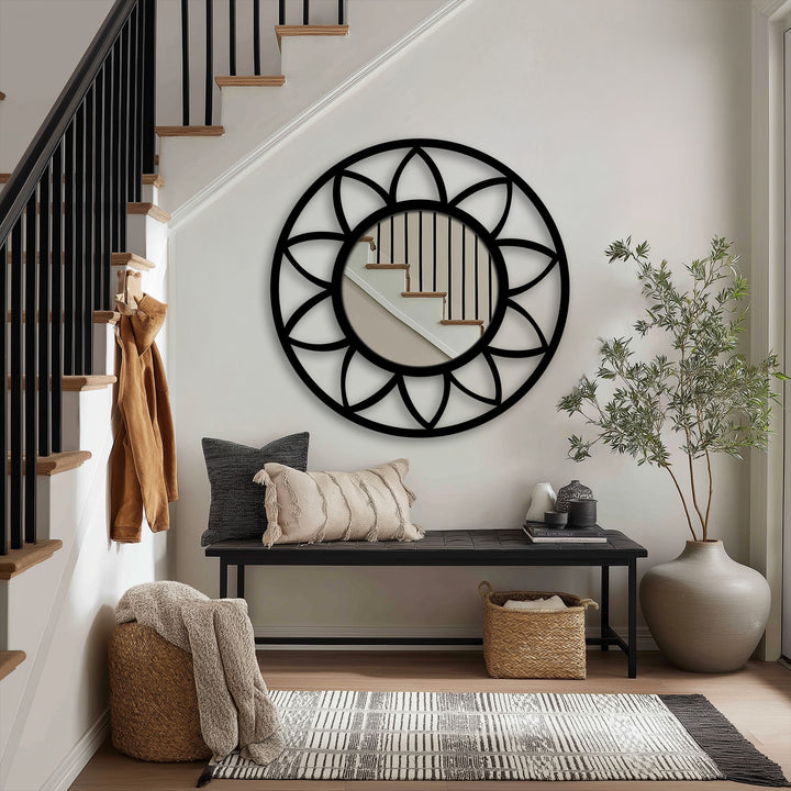 The round petal frame floor mirror creates a subtle sense of movement, its black lines drawing the eye through reflections like a stained glass wall mirror.