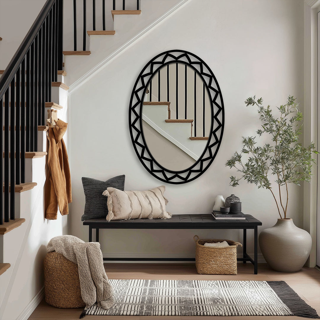 Behind the black geometric oval floor mirror, the neutral background showcases a modern staircase and minimalist home decor.