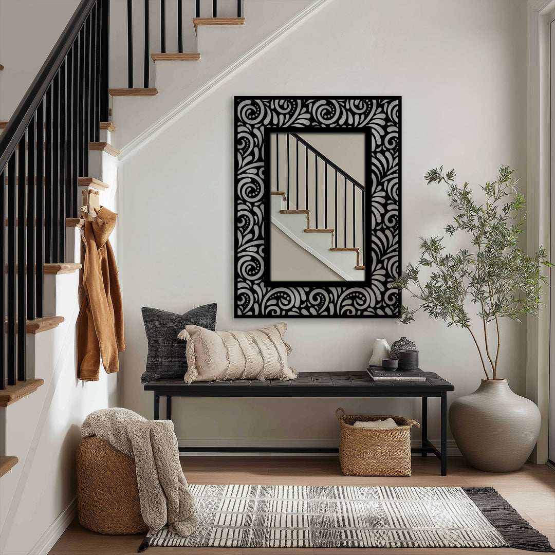 Highlighting the layering effect, the stained glass wall mirror shows an ornate scroll pattern that adds depth behind a black metal frame.