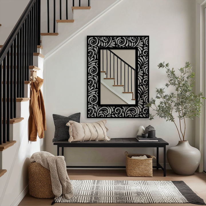 Highlighting the layering effect, the stained glass wall mirror shows an ornate scroll pattern that adds depth behind a black metal frame.