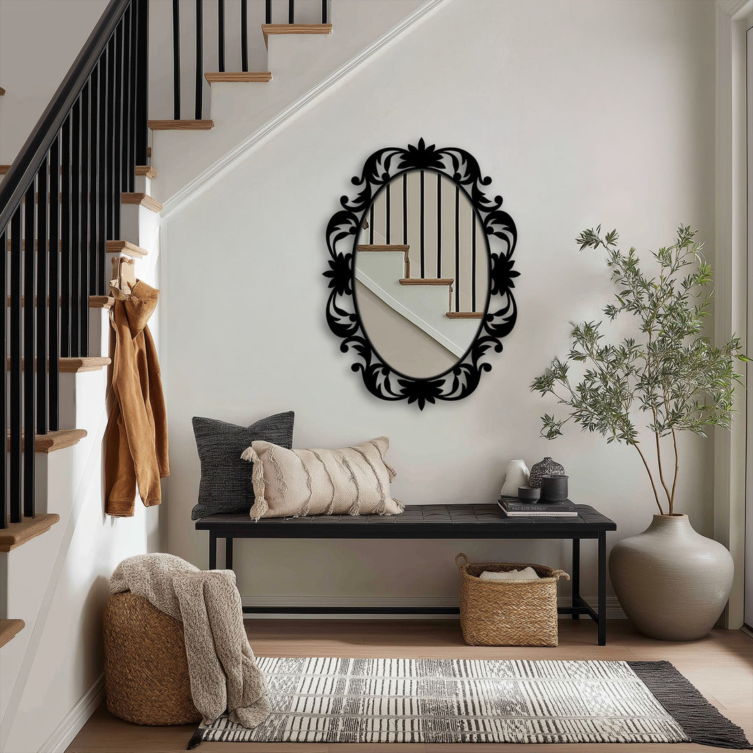 Geometric symmetry defines this modern mirror with its decorative oval frame reflecting the linear staircase and banister, creating a balanced focal point.