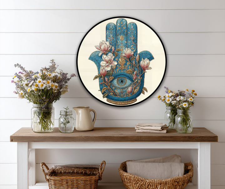 Alternating floral patterns and the turquoise Hamsa create a striking visual rhythm in this round oil painting reproduction print of a mystical hand with an eye.