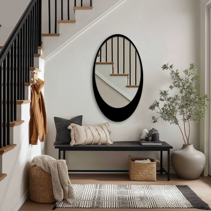 Light and shadow play across the sleek black frame of the minimal oval floor mirror, enhancing its modern design as a unique decoration wall art piece.
