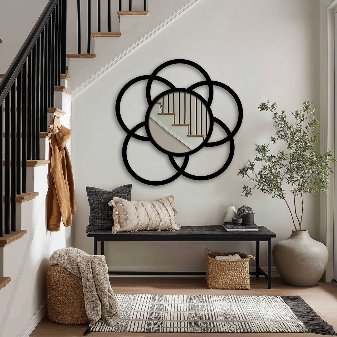 Reflecting stairs in its central circle, the modern interlock circle floor mirror is a striking stained glass wall mirror surrounded by a bold, black, geometric frame.
