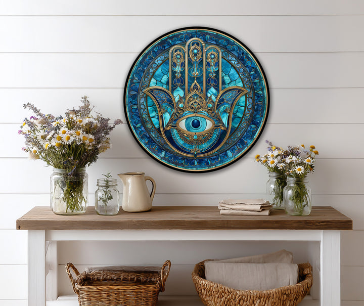 Light and shadow play across the protective eye in this blue Nazar Hamsa oil painting reproduction print, highlighting the intricate gold detailing on a round wood canvas.