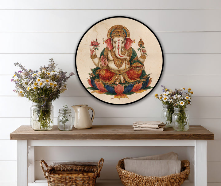 The stillness of the traditional Hindu round oil painting wall art highlights the serene Lord Ganesha seated on a lotus, a scene of calm divinity.