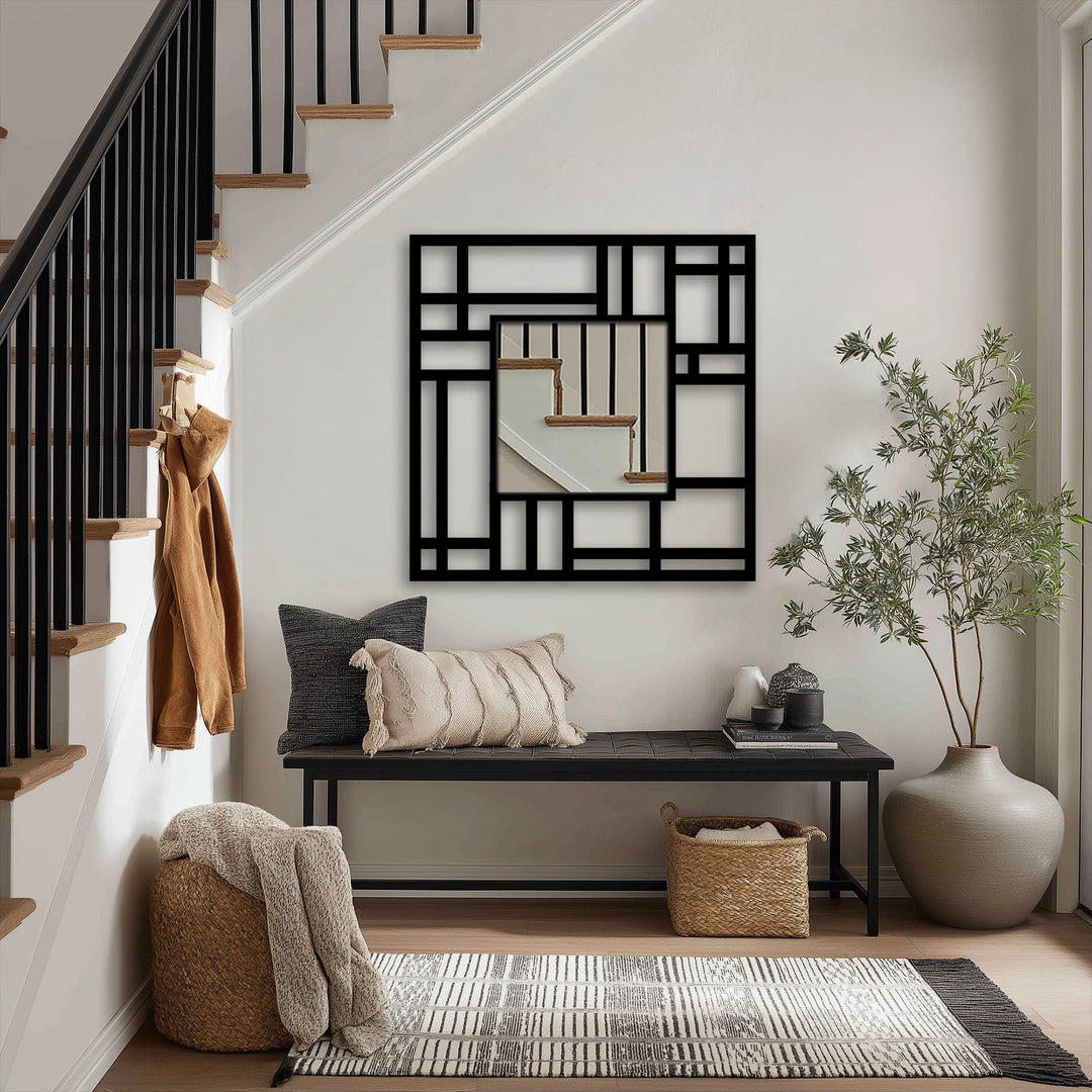 Cream-colored fringed cushion offers a soft contrast to the geometric Structured Grid metal mirror for wall decor in an entryway, with its modern design.