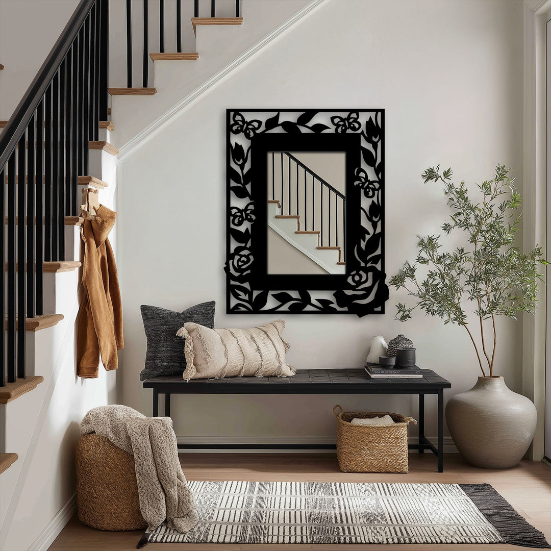 Shadows accentuate the floral and butterfly design of this metal artwork mirror, adding depth and intrigue to its elegant frame.