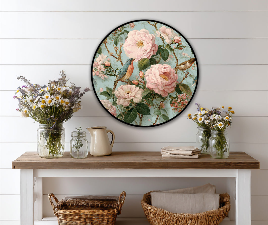 Soft light and shadow enhance the romantic appeal of the Blossoming Garden with Songbirds round oil painting decoration, creating depth among the pink blossoms and delicate birds.