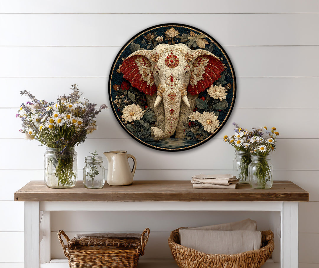 Round wood art displays a sacred elephant with crimson ears surrounded by flowers in an ornamental oil painting home decor scene.