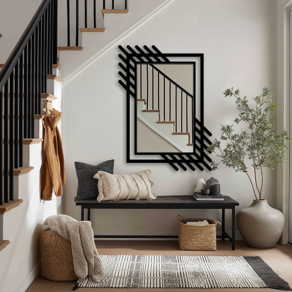 The metal wall mirror features a bold decorative metal art frame with an abstract linear border, adding a geometric accent to the contemporary design.