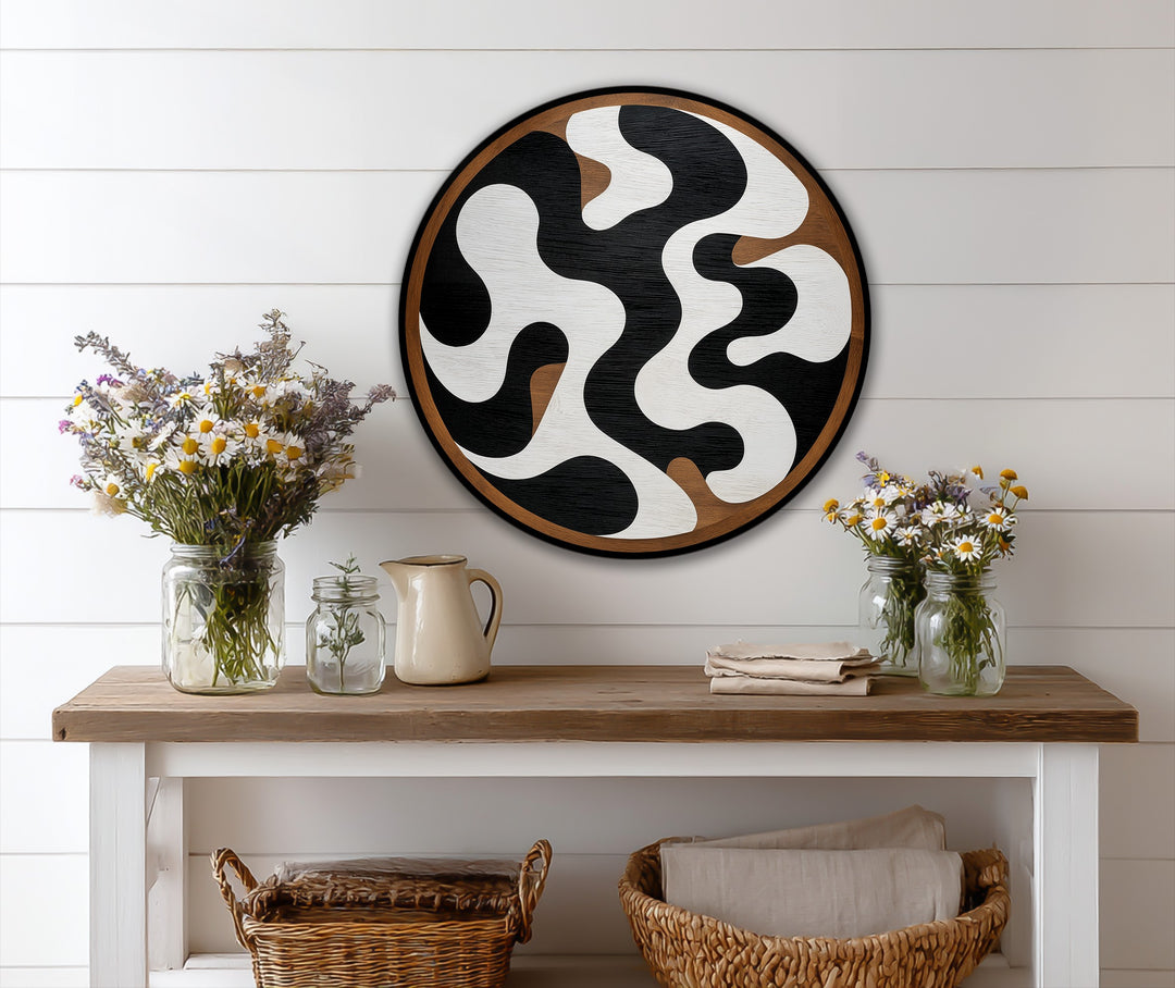 The darkest area shows the dramatic contrast in this abstract round oil painting art piece, with black flowing shapes against a white backdrop.