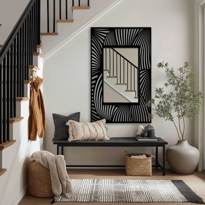 Visual rhythm is created by the repetition of flowing wave line patterns in this floor mirror's modern black frame, bringing a captivating metal wall decor element to the entryway.