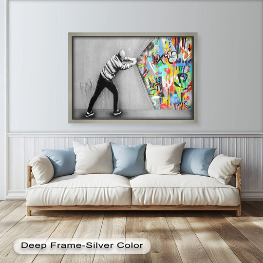 Bright, graffiti-style colors explode from behind the grey facade in this striking oil painting home decor featuring Banksy's 'Unveiling the Chaos.'