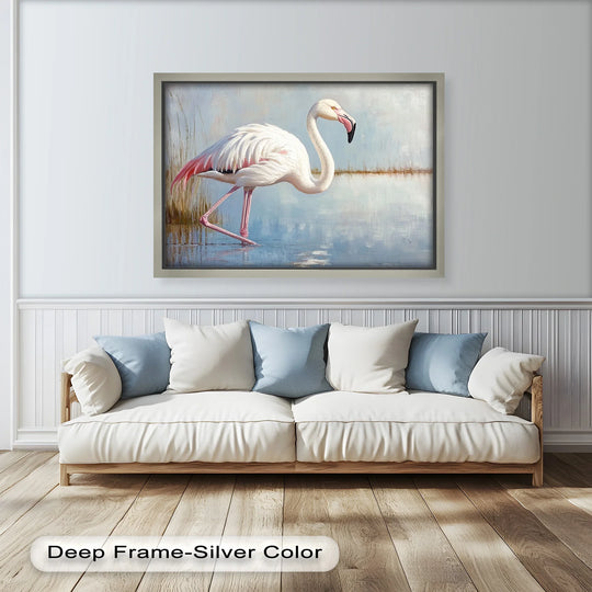 Foreground hardwood flooring basks in sunlight beneath a couch and framed oil painting reproduction print of a graceful flamingo wading in muted, shallow water.