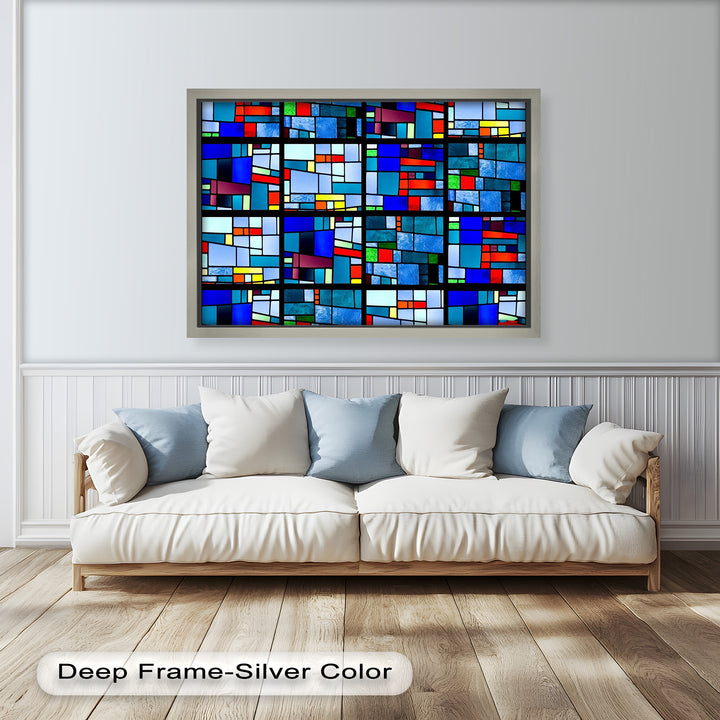 An abstract pattern of bold squares and rectangles in cool and warm hues, divided by thick black lines.