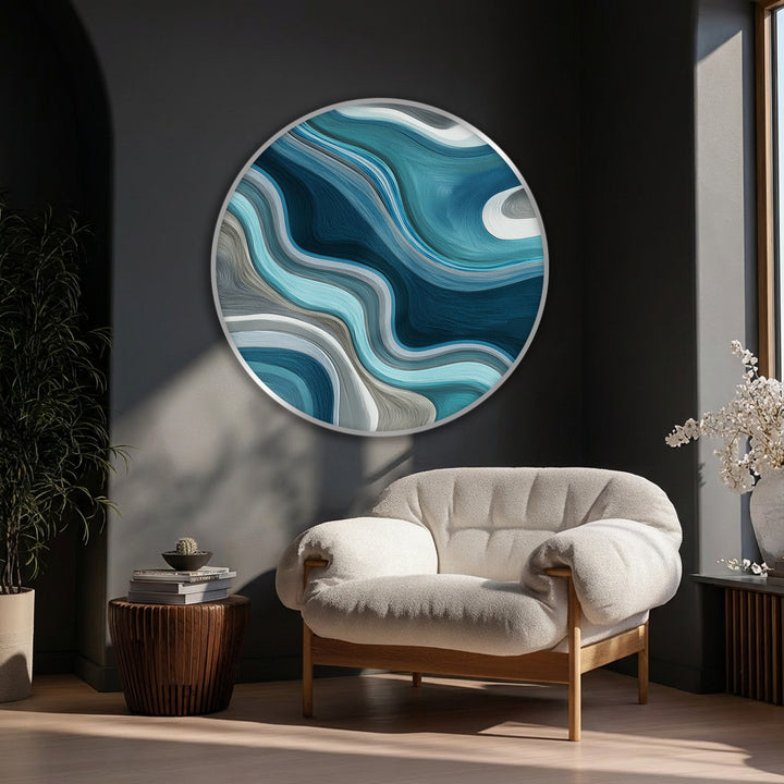 Featuring circular geometry, this round canvas presents big canvas prints of fluid teal waves as a modern abstract art form.