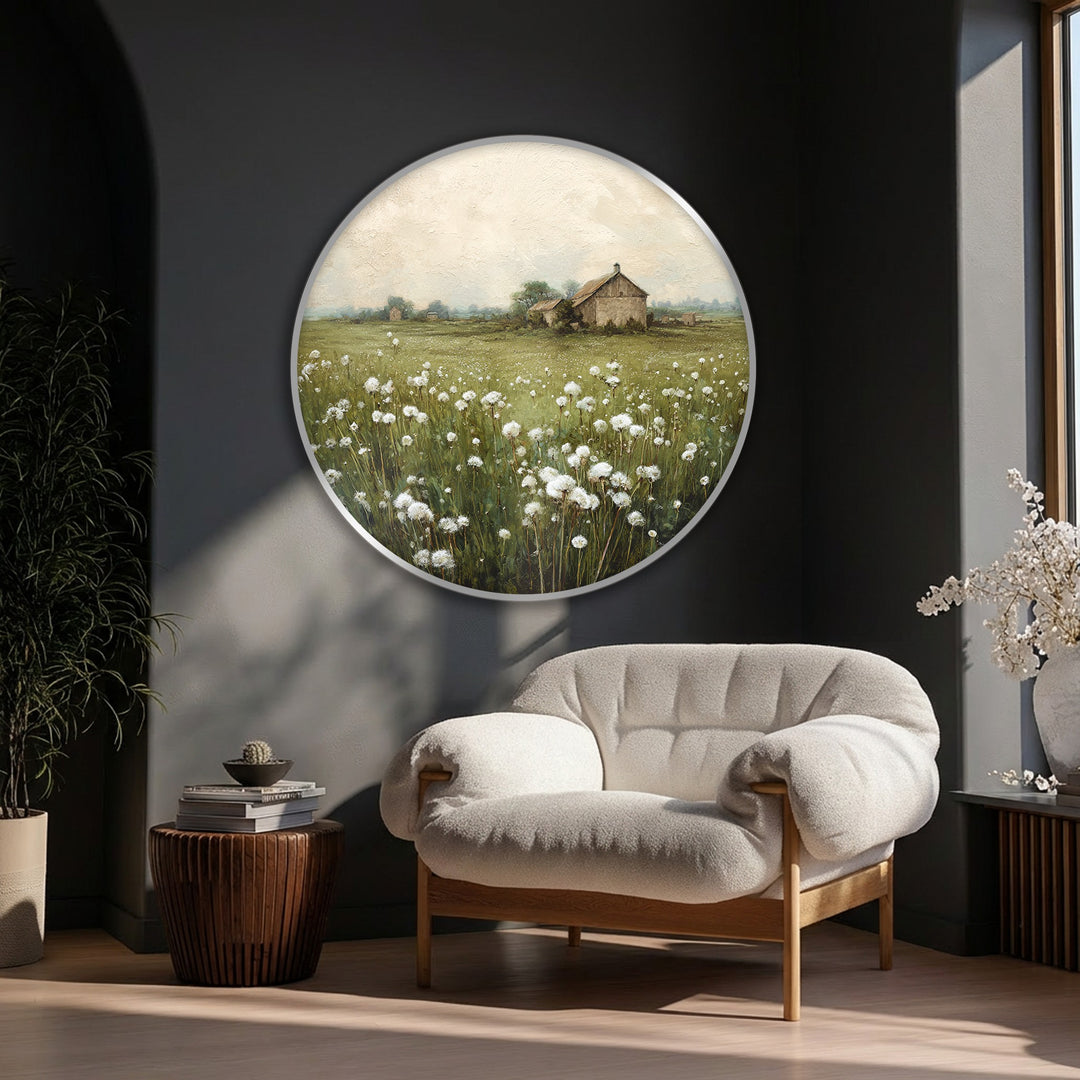 Featuring a circular canvas artwork, the field of white dandelions in full bloom creates soft, organic forms contrasted by the distant rustic barn.