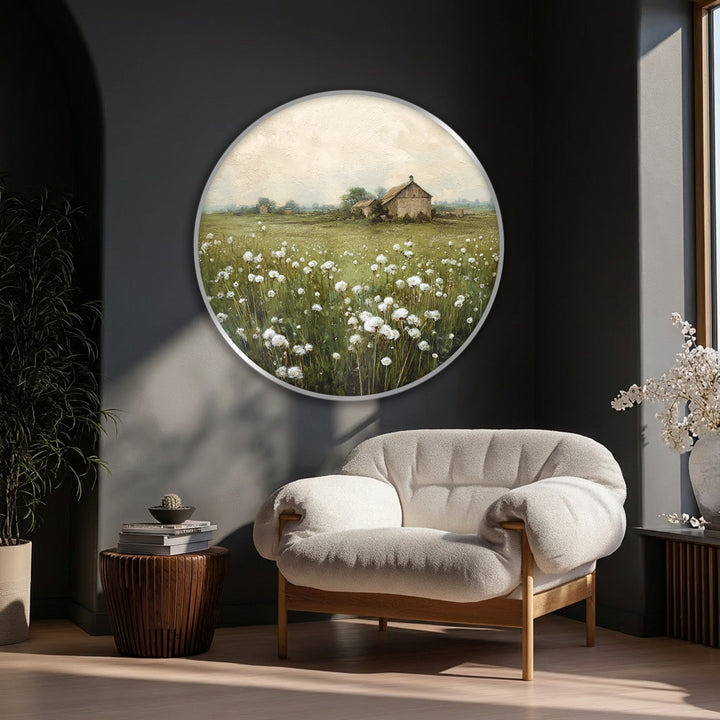 Featuring a circular canvas artwork, the field of white dandelions in full bloom creates soft, organic forms contrasted by the distant rustic barn.