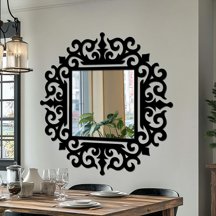 Warm color temperature highlights the black ornate baroque frame around the square royal scroll modern wall mirrors hung on a neutral wall.