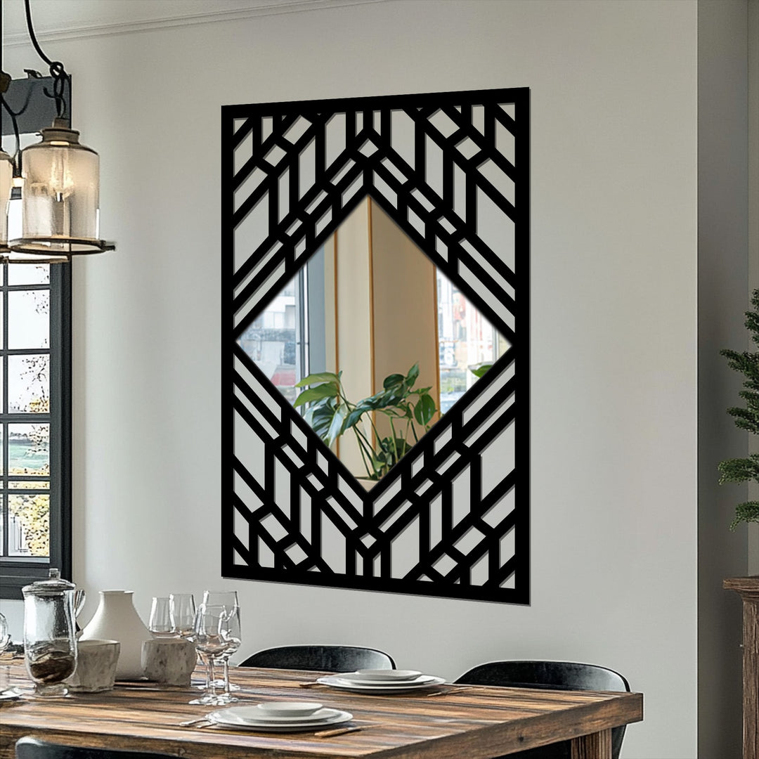 Reflected in the framed wall mirror's smooth surface, a vibrant green plant softens the bold geometric pattern of the Art Deco layered line frame.