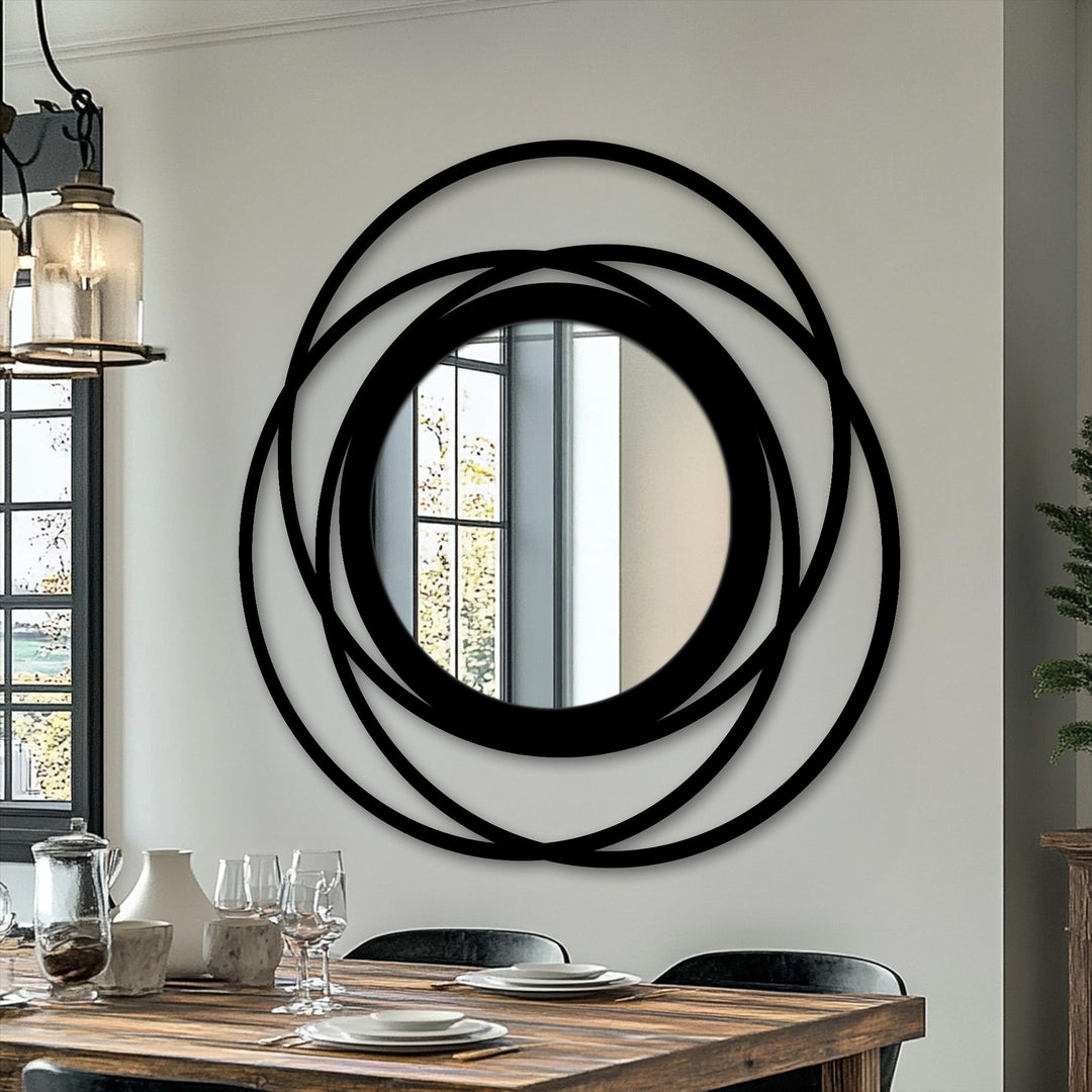 Black is the dominant color in this intertwined ring circle floor mirror, a striking piece of metal artwork with a bold, modern design.